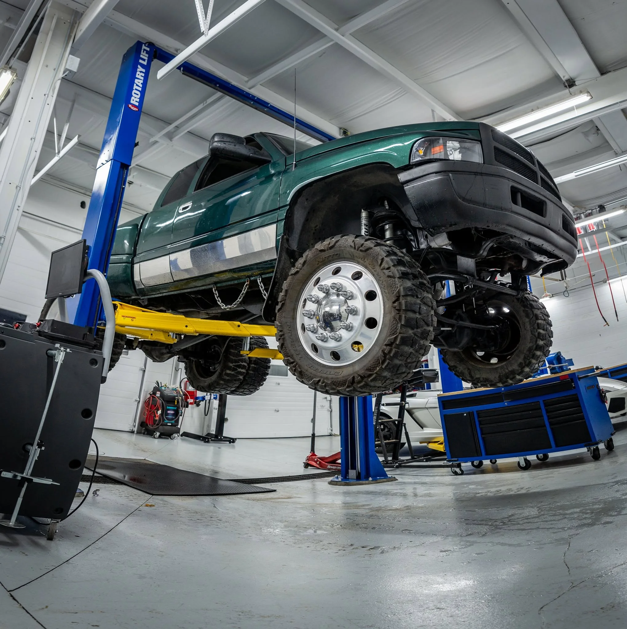 Lifted diesel truck on a hoist at Western Gas and Diesel